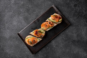 Delight in an array of gourmet dishes and beverages presented on a sleek black plate, showcasing the artistry of contemporary cuisine at a vibrant restaurant