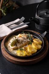 Culinary delights grace a beautifully arranged plate, featuring succulent meat and perfectly roasted potatoes, all presented with artistry in a cozy dining environment