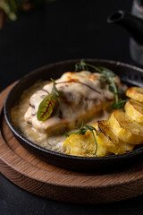 Savor the delightful combination of perfectly cooked fish accompanied by golden, roasted potatoes and fresh herbs, served in a stylish restaurant ambiance after sunset