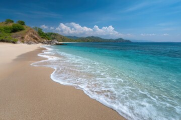 Fototapeta premium Serene Coastal Beach: Golden Sand, Turquoise Waters, and Gentle Waves