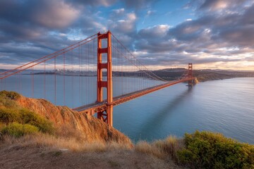 Fototapeta premium Golden Gate Bridge Sunrise: Majestic Structure, Serene Coastal Panorama