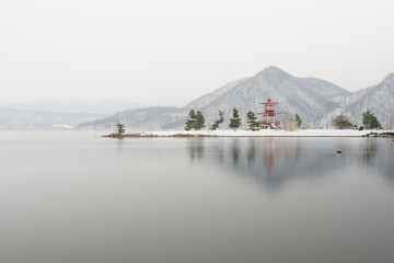 lake and mountains with japanese shrine