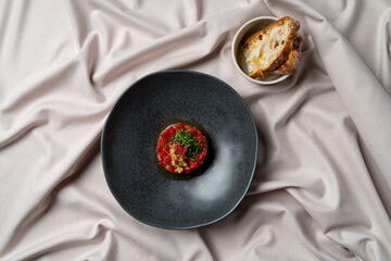 A meticulously crafted gastronomic dish showcases diced tomatoes and herbs, presented on a modern...