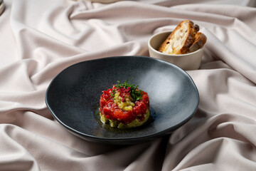 A visually stunning dish showcases gourmet ingredients meticulously arranged on a sleek black plate