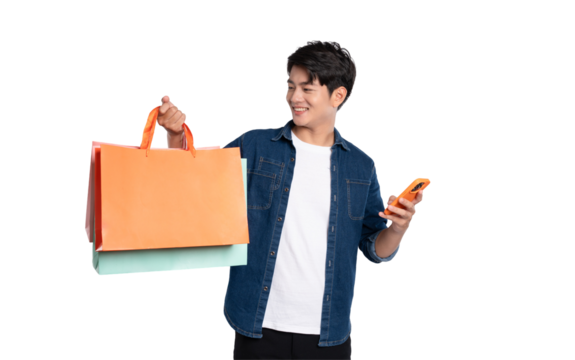 Portrait of young Asian man using phone and holding shopping bag posing on PNG background	