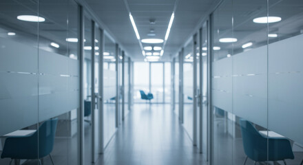 Obraz premium Modern office corridor with glass partitions and blurred background