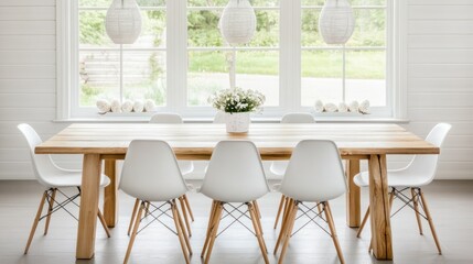 A light-filled dining area with a large wooden table and white chairs.