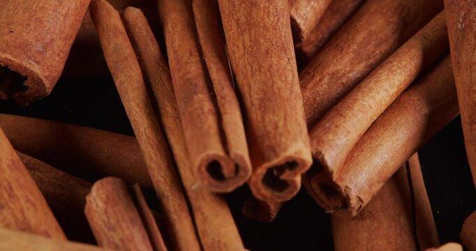 Cinnamon sticks rotate as a background. Fragrant cinnamon close-up. Spices with cinnamon. Food cooking video concept.