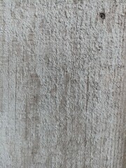 Fototapeta premium Aged Wooden Surface with Cement Texture Overlay. A rustic wooden plank layered with cement residue, showing aged wood grain, scratches, and textured surface patterns