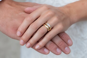 Intertwined Golden Bands: A Close-Up of Wedding Rings