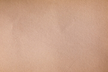 Texture of a weathered, pale brown kraft paper sheet