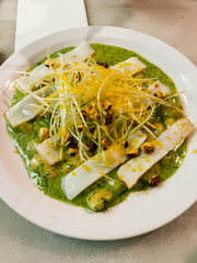 Creative culinary plating that combines textures, colors, and flavor contrasts in refined...