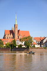 Obraz premium Wroclaw Poland 09.21.2025 Emergency services patrol the flooded Odra River during high water levels in the city. The patrol boat is seen near Cathedral on Tumski Island amid flood response operations.