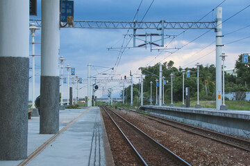 Taiwan May 21, 2024: A railway track curving into the distance beside a station platform,...