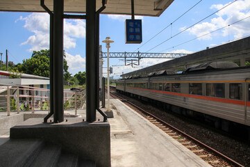 Regional Taiwan Railways train arriving at platform 5 of Fuli Station in Hualien under a bright...