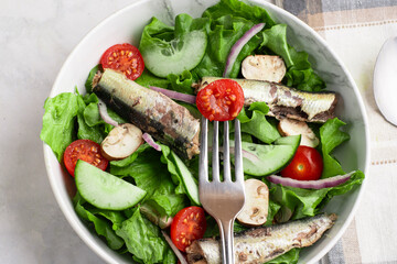 garden salad  top with  mushrooms and sardines