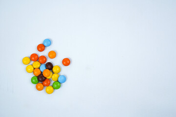 Colorful Candy Scatter: A vibrant assortment of candies, boasting a spectrum of colors and shapes,...