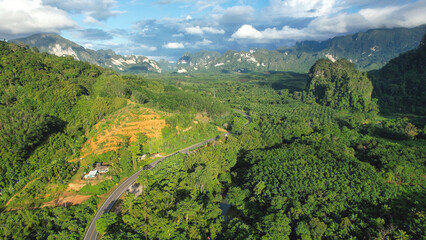 Obraz premium Aerial view of the road among mountains and rainforest in Khao Sok, Surat Thani Thailand