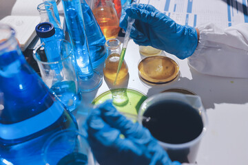 Scientist pipetting medical samples into microplate in laboratory