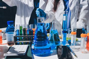 Scientist pipetting medical samples into microplate in laboratory