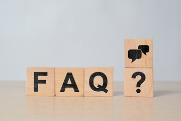 Wooden cube blocks with FAQ text (frequently asked questions) on table background. Financial,...