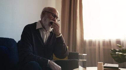 Upset elderly man taking pill with water, senior vitamins and health support - Powered by Adobe