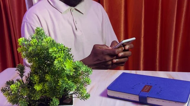 man holding and using mobile phone
