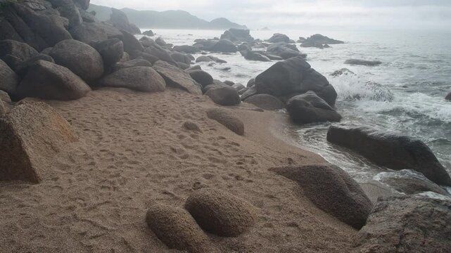 The coast of the Sea of Japan with coastal water-worn rocks, beach scarp. klip, rocky islets (skerry), seacoast erosion, Eastern Siberia, Primorsky Krai