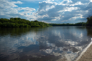 Landscape with river and clouds.
Reflection of clouds on the water surface gives the image a sense of volume and depth of space.
