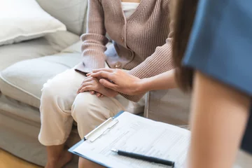 Fototapeten Young woman in a mental therapy session talking with a psychologist in the office. © Pormezz