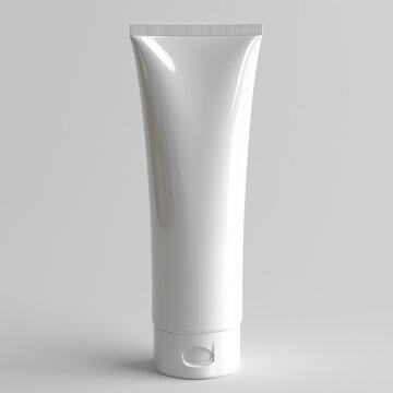 A white tube of toothpaste is shown in a close up. The tube is empty and has a white cap. The image is in black and white