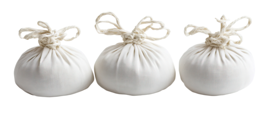 Set of herbal compress balls wrapped in white cloth with string ties