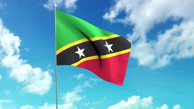 The flag of the Federation of Saint Kitts and Nevis flies in the blue sky.
