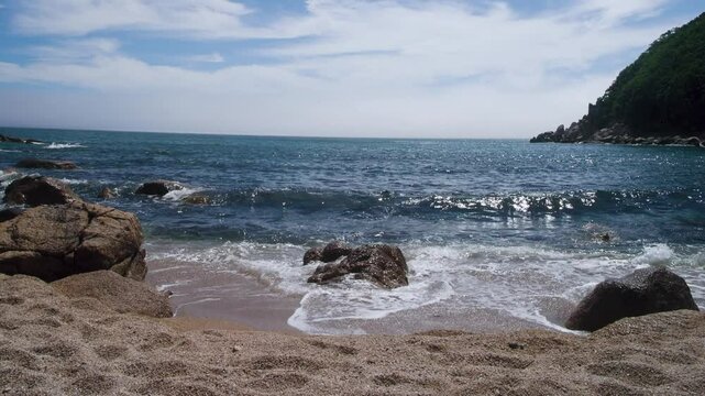 The coast of the Sea of Japan with coastal water-worn rocks, beach scarp. klip, rocky islets (skerry), seacoast erosion, Eastern Siberia, Primorsky Krai