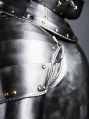 Detailed close-up photo showcasing the craftsmanship of polished metallic medieval armor with...