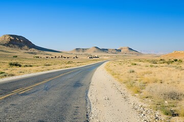 Deserted Highway Leading To Ancient Ruins In Arid Landscape