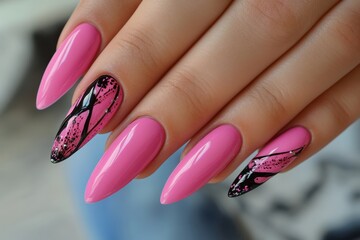 Close up of a manicured female hand showing off stiletto shaped pink nails with artistic black and silver glitter designs, creating a stylish and fashionable look