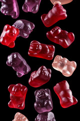 Gummy Bears Falling on Black Background.