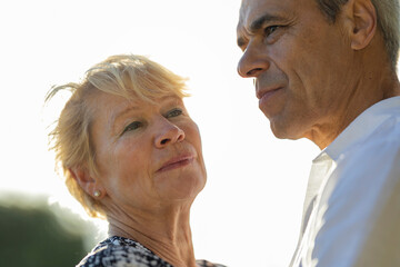Senior couple looking away expressing concern and hope