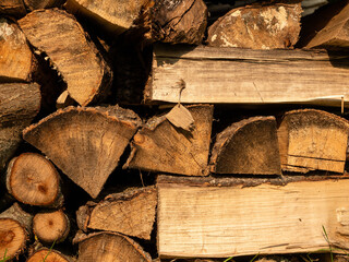 A stack of logs with some grass in between them. The image has a calm and tranquil atmosphere, with...