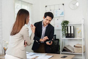 Engaging Meeting. Professionals collaborating over digital device in office.