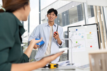 Collaborative ESG Planning. Young architect discussing sustainability with colleague.