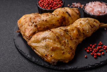 Grilled chicken leg or quarter. Barbecued meat with salt and spices