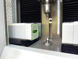 Naklejka premium Precision manufacturing process involving advanced machinery with a focus on detailed measurements and quality control in industrial setting