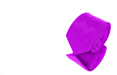 A necktie rolled on white background closeup view 