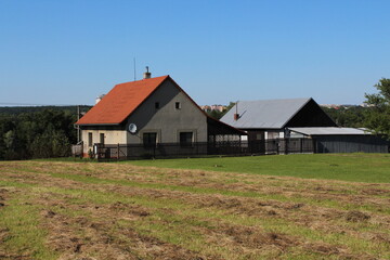 Obraz premium Old grey family house with red tilled roof