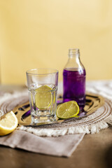 A vibrant mix of lime tonic and purple soda served in a chilled glass, showcasing a refreshing citrus twist and bold color contrast, perfect for advertisements, branding, and modern beverage campaigns