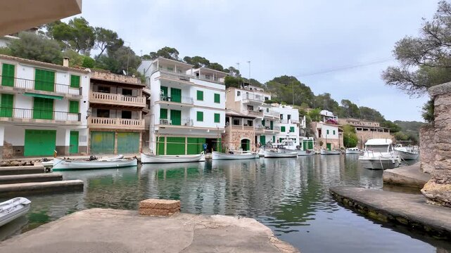 Traditional llauts and modern boats moored in the charming harbor of cala figuera, a scenic fishing village on the island of majorca