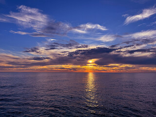Beautiful sunset sky clouds over ocean 