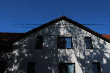 Old white family house with red roof 